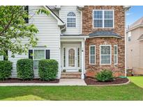 Charming entryway with a white front door, stone accents, and well-maintained landscaping at 910 Pebble Creek Trl, Suwanee, GA 30024