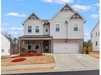 Charming two-story home featuring a large two-car garage and appealing architectural details at 2456 Hidden Creek Rd, Kennesaw, GA 30152