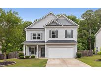 Charming home with a manicured lawn, two car garage and covered front porch at 197 Cherokee Reserve Cir, Canton, GA 30115