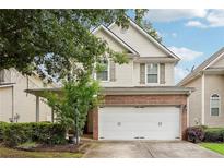Charming two-story home featuring a brick-accented garage and well-maintained landscaping at 2545 Gatewater Ct, Cumming, GA 30040
