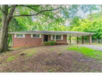 Charming brick ranch-style home featuring a covered carport and well-maintained landscaping at 4567 Parkway Cir, Atlanta, GA 30349