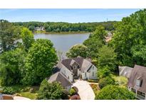 Stunning waterfront home with lush landscaping, private drive and lake view at 507 Cross Creek Pt, Stone Mountain, GA 30087