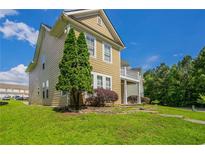 Charming two-story home with a landscaped yard on a sunny day at 4634 Garden Hills Dr, Stone Mountain, GA 30083