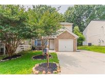 Charming brick-accented two-story home featuring a well-manicured front lawn and a single-car garage at 7070 Ravenwood Ln, Lithonia, GA 30038