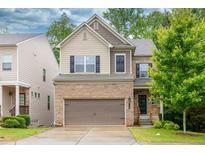 Two-story home with a brick and siding exterior, attached garage, and well-maintained lawn at 118 Hardy Water Dr, Lawrenceville, GA 30045