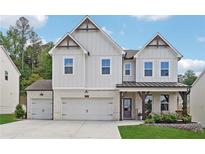 Charming two-story home with brick accents, a three-car garage, and a well-manicured lawn at 2445 Hidden Creek Rd, Kennesaw, GA 30152