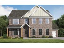 Charming two-story brick home featuring a covered front porch and well-manicured lawn at 609 Villa Rica Spgs, Villa Rica, GA 30180