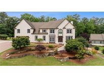Charming two-story home with a beautifully landscaped front yard and classic architectural details at 615 Lovinggood Trl, Woodstock, GA 30189