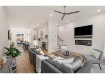 Bright living room featuring hardwood floors, modern furniture, and an open floor plan to the kitchen and dining area at 1237 Memorial Se Dr # 303, Atlanta, GA 30316