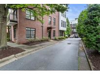Brick condo building with black framed windows and mature landscaping at 1300 Dekalb Ne Ave # 711, Atlanta, GA 30307