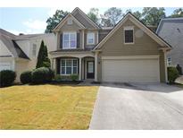 Charming two-story home with a well-maintained lawn and two car garage at 942 Idlewood Dr, Canton, GA 30115