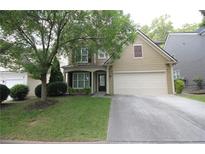 Charming two-story home with well-manicured lawn and inviting curb appeal and a two car garage at 942 Idlewood Dr, Canton, GA 30115
