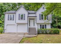 Charming two-story home featuring white siding, black shutters and trim, and a well-maintained front yard at 159 Aztec Se Way, Acworth, GA 30102