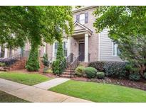 Charming two-story home with a brick facade, landscaped yard, and inviting front porch at 3937 Covey Flush Sw Ct # 25, Smyrna, GA 30082