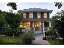 Charming two-story home featuring a welcoming front porch and beautifully landscaped front yard at 1602 Windsor Walk, Avondale Estates, GA 30002