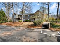 Inviting exterior of a gray two-story home with balconies and a landscaped entrance at 406 Country Park Se Dr, Smyrna, GA 30080