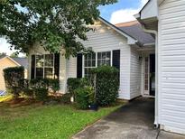 Charming home with white siding, black shutters, and well-maintained landscaping at 10600 Pine Forest Ln, Jonesboro, GA 30238