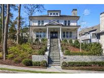 Stunning two-story white brick home with manicured landscaping and inviting staircase at 18 Polo Ne Dr, Atlanta, GA 30309