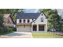 Charming two-story home featuring a blend of stone and siding, complemented by an attached two-car garage and landscaped front yard at 1115 Ralph Ne Rd, Atlanta, GA 30324