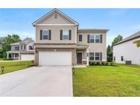 Charming two-story home featuring neutral siding, brick accents, a two-car garage, and a well-maintained lawn at 228 Whitneys Way, Dallas, GA 30157