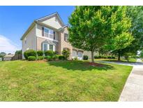 Charming two-story home with a well-manicured lawn and attached two-car garage at 3524 Preserve Run Trl, Loganville, GA 30052