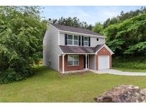 Charming two-story home with brick and vinyl siding and attached one car garage at 3915 Cypress Pointe Dr, Union City, GA 30291