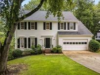 Charming two-story home with black shutters, a landscaped yard, and an attached two-car garage at 1981 Sumter Ct, Lawrenceville, GA 30044