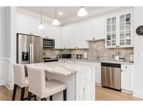 Bright kitchen features stainless appliances, marble countertops, and white cabinetry at 11 Perimeter E Ctr # 1412, Atlanta, GA 30346