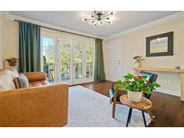 Inviting living room featuring hardwood floors and glass doors to a balcony with seating at 869 Briarcliff Ne Rd # B20, Atlanta, GA 30306
