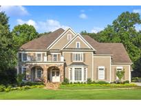 Beautiful two-story home with stone accents, manicured lawn, and inviting curb appeal at 443 Langley Oaks Dr, Marietta, GA 30067