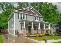 Charming two-story home with a welcoming front porch, stone accents, and well-manicured lawn at 176 Olympic Pl, Decatur, GA 30030