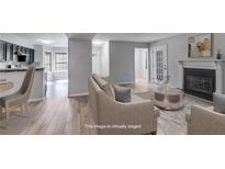 Bright living room featuring a fireplace, wood floors and an open floor plan at 2135 N Forest Trl, Dunwoody, GA 30338