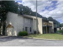 Two-story condo featuring balconies, landscaped lawns, and a mix of siding and stucco exterior at 3575 Oakvale Rd # 919, Atlanta, GA 30034