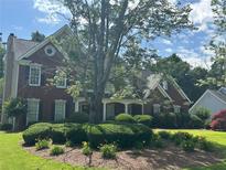 Beautiful two-story brick home with manicured landscaping and a charming front porch at 2295 Amberbrook Lane Ln, Grayson, GA 30017