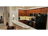 A well-equipped kitchen features granite counters, wooden cabinets, and modern appliances at 3150 Woodwalk Se Dr # 3112, Atlanta, GA 30339