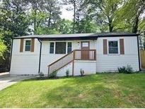 Charming single-Gathering home with white siding, inviting front porch, and well-manicured lawn at 2190 Gordon Se Cir, Smyrna, GA 30080