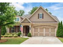 Charming home with a well-manicured lawn and a two-car garage that provides curb appeal at 2965 Westlington Cir, Cumming, GA 30040