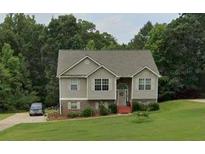 Charming two-story home with well-maintained lawn, driveway, and mature trees at 45 Avery Drive, Covington, GA 30016