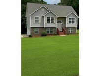 Charming two-story home with a well-manicured front yard and a welcoming entrance at 45 Avery Drive, Covington, GA 30016