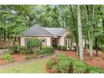 Charming one-story home featuring manicured landscaping and neutral exterior paint at 120 Bent Creek Dr, Woodstock, GA 30189