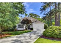 Charming single-story home with a manicured lawn, a two-car garage, and mature trees at 2059 Howell Mill Nw Rd, Atlanta, GA 30318
