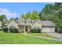 Charming single-Gathering home with well-manicured lawn, mature trees, and attached two car garage at 1907 S Van Wert Rd, Villa Rica, GA 30180