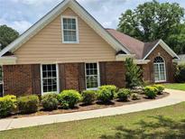 Charming brick home with well-manicured landscaping and a welcoming facade at 512 Ollas Walk, Mcdonough, GA 30252