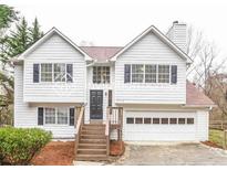 Charming two-story home with an attached garage and inviting front porch steps at 5710 Cardigan Trce, Sugar Hill, GA 30518