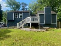 The backyard with a patio and well-maintained lawn provides a private space at 6701 Knollwood Cir, Douglasville, GA 30135