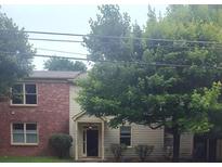 Charming two-story home featuring a brick facade and lush landscaping at 1707 Taylor Ave, Atlanta, GA 30344