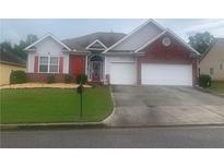Charming single-story home featuring a well-manicured lawn, red shutters, and an attached two-car garage at , Atlanta, GA 30331