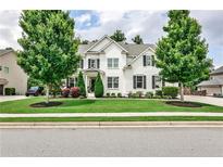 Beautiful two-story home featuring a well-manicured lawn and lush landscaping at 148 Sierra Cir, Woodstock, GA 30188