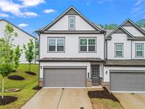 Charming townhome with a well-maintained lawn and a two-car garage at 359 Crider Ct, Woodstock, GA 30188