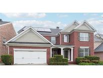 Elegant brick two-story home featuring a two-car garage and neatly manicured landscaping at 1489 Belmont Hills Dr, Suwanee, GA 30024